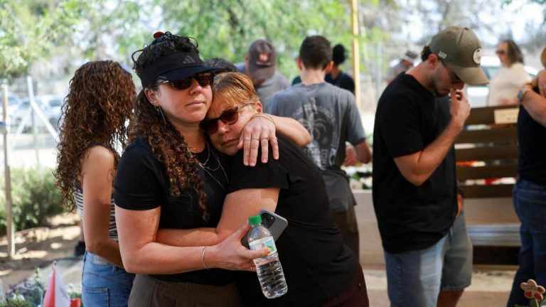 A woman comforts a mourner at a memorial ceremony for the community of Kibbutz Kfar Aza, on the third anniversary of the Hamas-led attack on Israel on 7 October 2023, in Kfar Aza, southern Israel (7 October 2026)