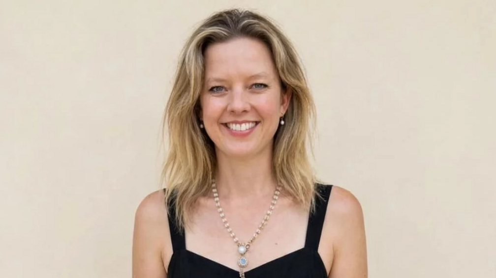 Dr Hannah Terry smiles at the camera. She has blonde hair and is wearing a black dress.